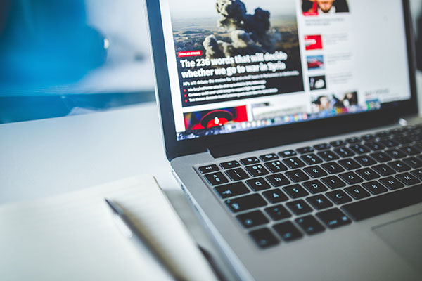 reading news on laptop