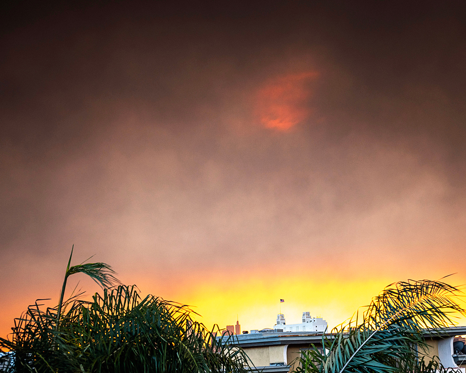 Smoke from the January 2025 wildfires light up the sunrise over downtown Los Angeles, CA.
